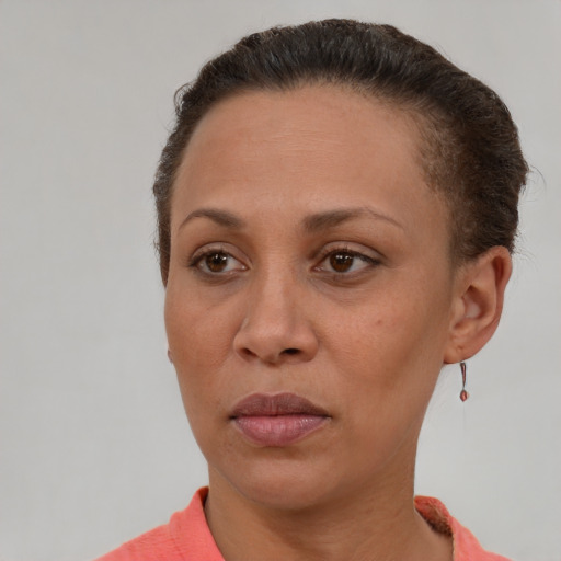 Joyful latino adult female with short  brown hair and brown eyes