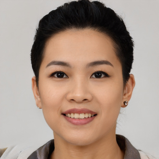 Joyful asian young-adult female with short  black hair and brown eyes