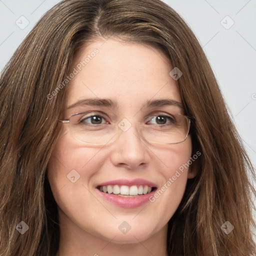 Joyful white young-adult female with long  brown hair and green eyes