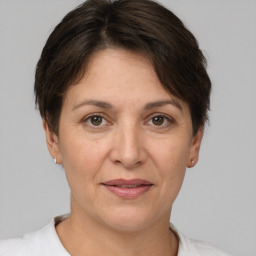 Joyful white adult female with short  brown hair and brown eyes