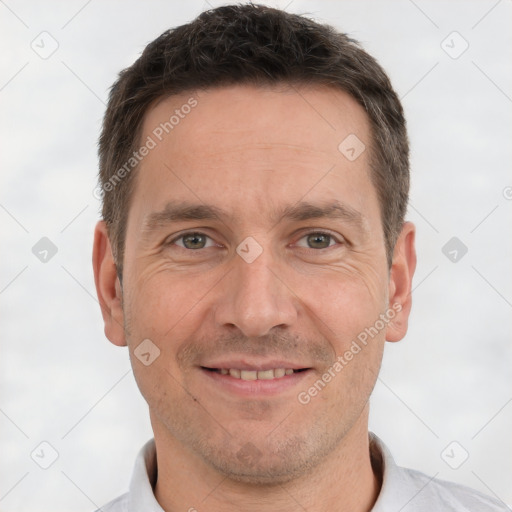 Joyful white adult male with short  brown hair and brown eyes