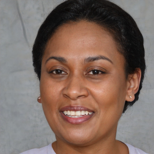 Joyful latino young-adult female with short  brown hair and brown eyes