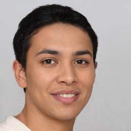 Joyful latino young-adult male with short  brown hair and brown eyes