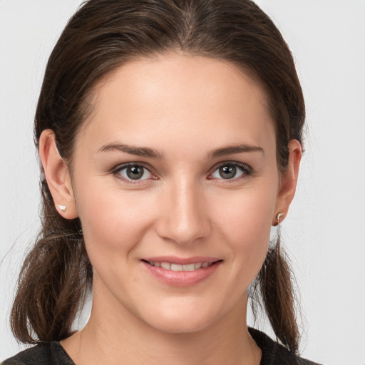 Joyful white young-adult female with medium  brown hair and brown eyes