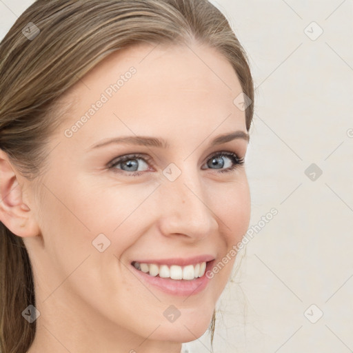 Joyful white young-adult female with long  brown hair and blue eyes