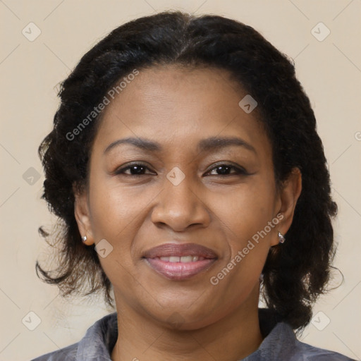 Joyful black adult female with medium  brown hair and brown eyes