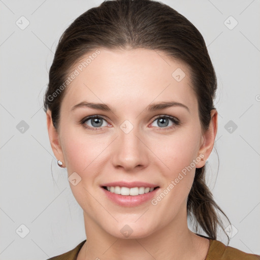 Joyful white young-adult female with medium  brown hair and grey eyes