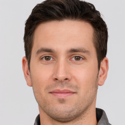 Joyful white young-adult male with short  brown hair and brown eyes