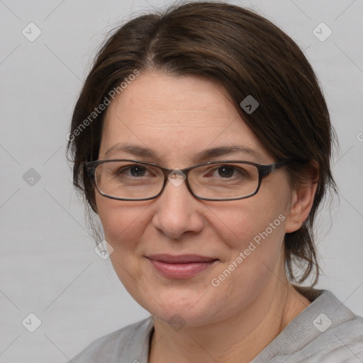 Joyful white adult female with medium  brown hair and brown eyes