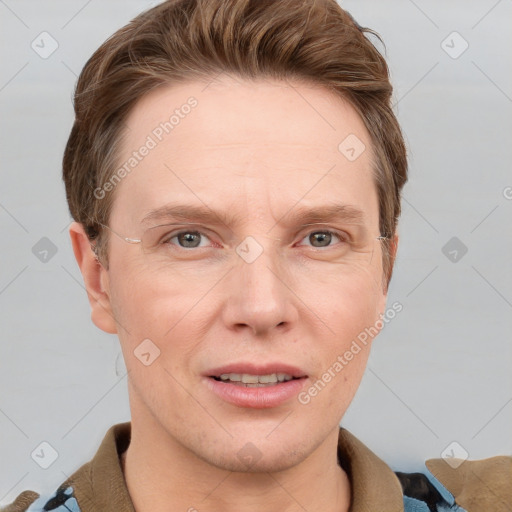 Joyful white adult male with short  brown hair and grey eyes