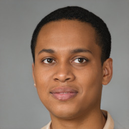 Joyful black young-adult male with short  brown hair and brown eyes