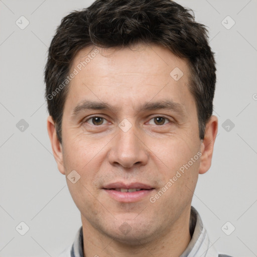 Joyful white adult male with short  brown hair and brown eyes