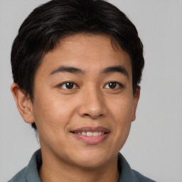 Joyful asian young-adult male with short  brown hair and brown eyes