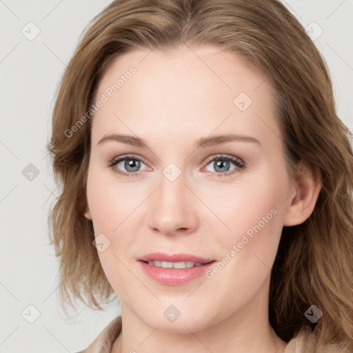 Joyful white young-adult female with long  brown hair and blue eyes