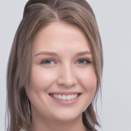 Joyful white young-adult female with long  brown hair and blue eyes