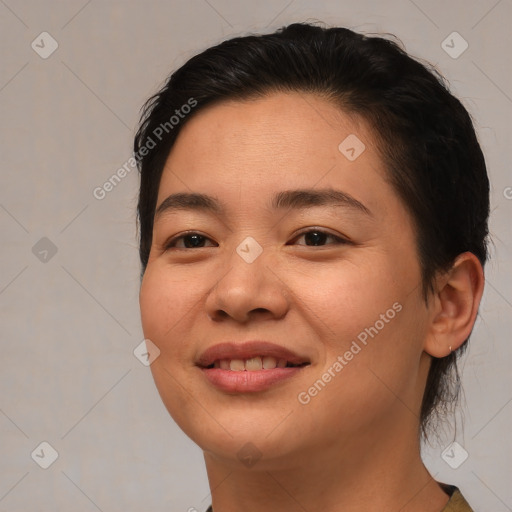 Joyful asian young-adult female with medium  brown hair and brown eyes