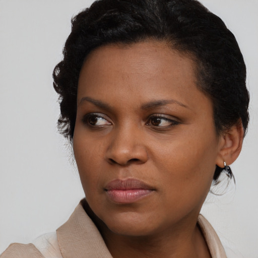Joyful black young-adult female with medium  brown hair and brown eyes