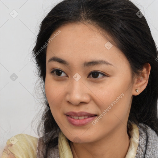 Joyful latino young-adult female with medium  brown hair and brown eyes