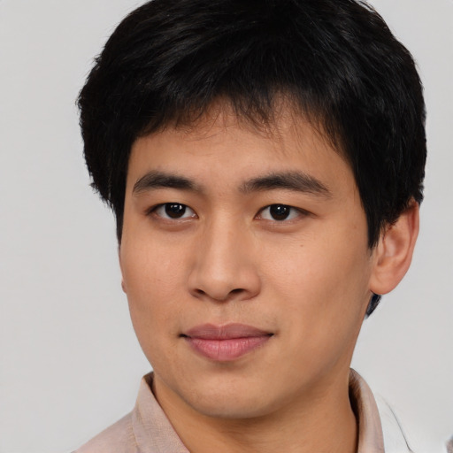 Joyful asian young-adult male with short  brown hair and brown eyes