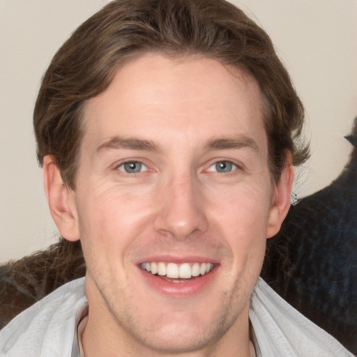 Joyful white adult male with medium  brown hair and grey eyes