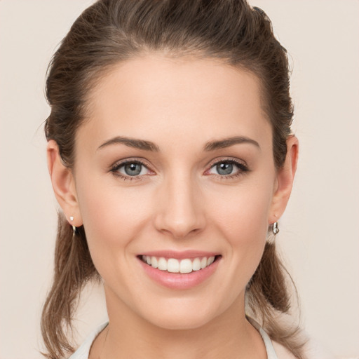 Joyful white young-adult female with medium  brown hair and green eyes