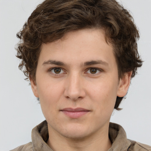 Joyful white young-adult male with medium  brown hair and green eyes