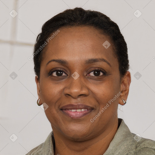 Joyful black adult female with short  brown hair and brown eyes