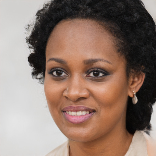 Joyful black young-adult female with medium  brown hair and brown eyes