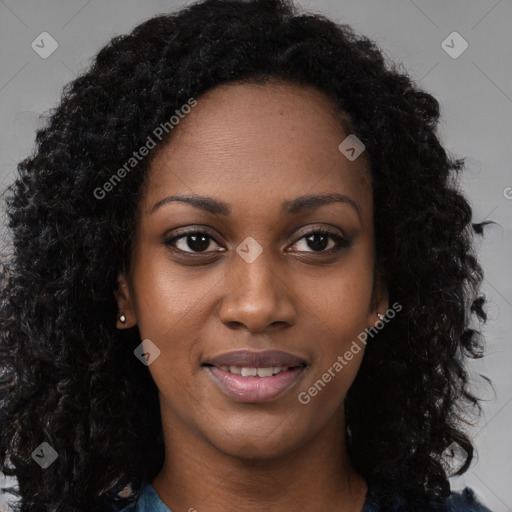 Joyful black young-adult female with long  brown hair and brown eyes