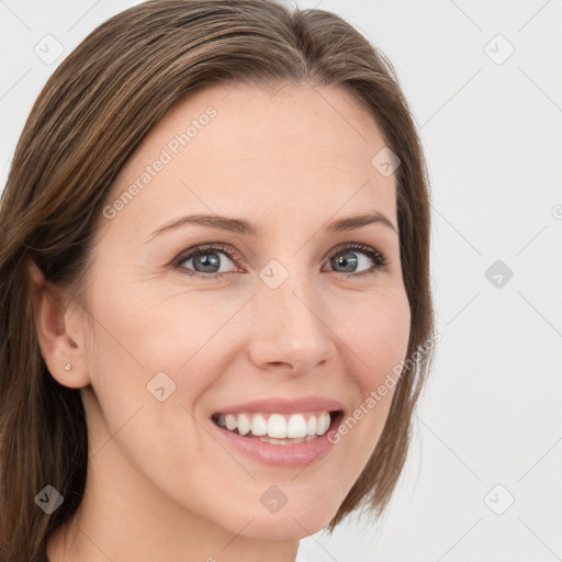 Joyful white young-adult female with long  brown hair and blue eyes