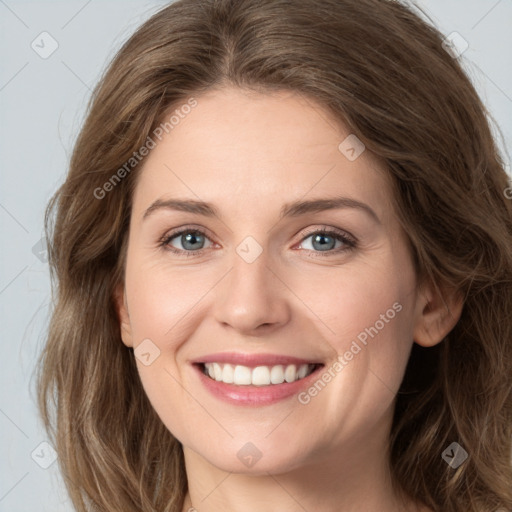 Joyful white young-adult female with long  brown hair and green eyes