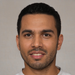 Joyful latino young-adult male with short  black hair and brown eyes