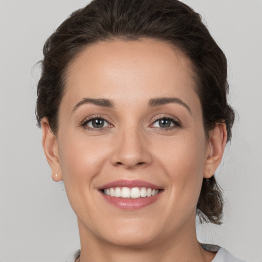 Joyful white young-adult female with medium  brown hair and brown eyes