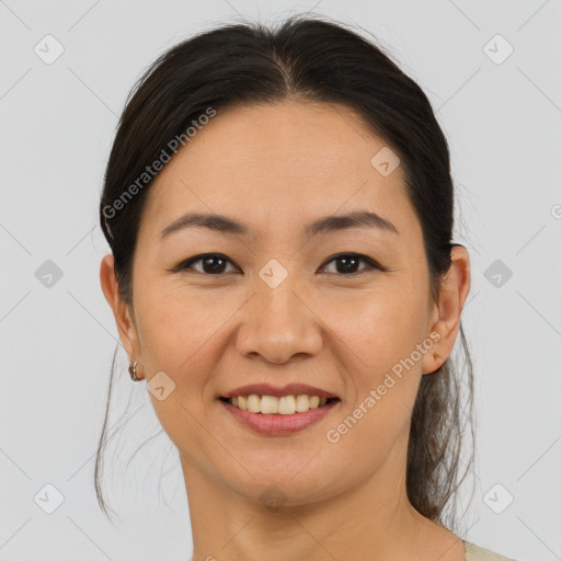 Joyful asian adult female with medium  brown hair and brown eyes