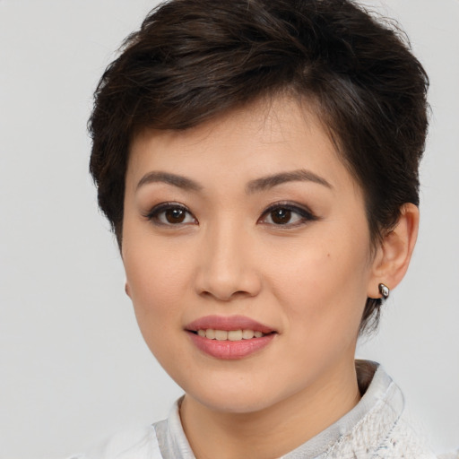 Joyful white young-adult female with short  brown hair and brown eyes