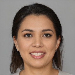 Joyful latino young-adult female with medium  brown hair and brown eyes