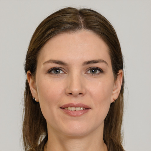 Joyful white young-adult female with long  brown hair and grey eyes