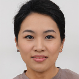 Joyful asian young-adult female with short  black hair and brown eyes