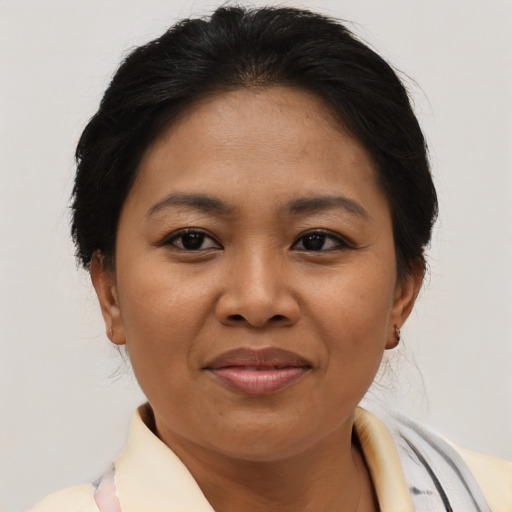 Joyful asian adult female with short  brown hair and brown eyes