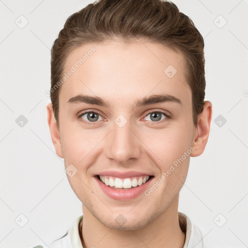 Joyful white young-adult male with short  brown hair and grey eyes