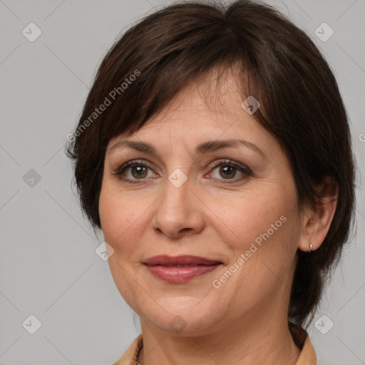 Joyful white adult female with medium  brown hair and brown eyes