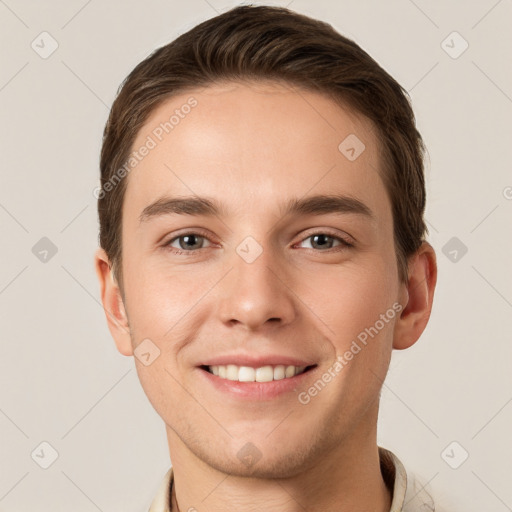 Joyful white young-adult male with short  brown hair and grey eyes