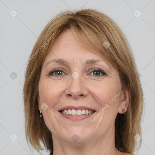 Joyful white adult female with medium  brown hair and grey eyes