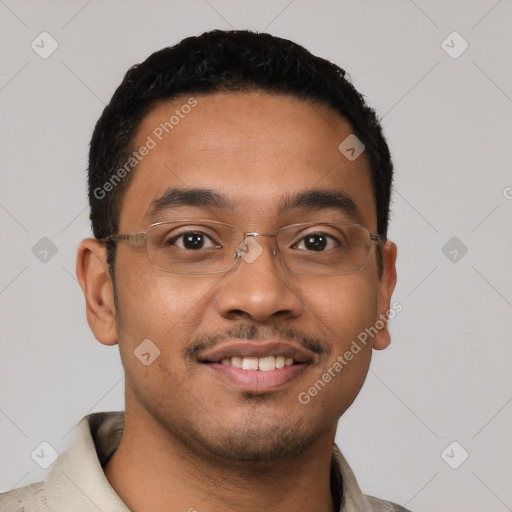 Joyful latino young-adult male with short  black hair and brown eyes