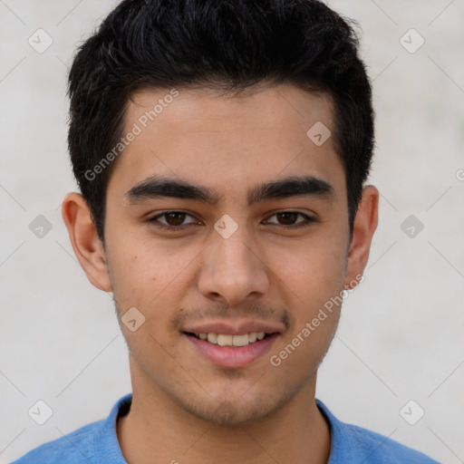 Joyful latino young-adult male with short  brown hair and brown eyes