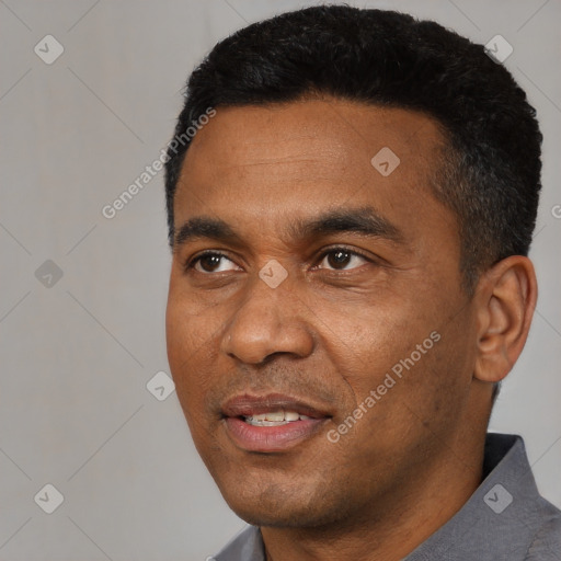 Joyful black adult male with short  black hair and brown eyes