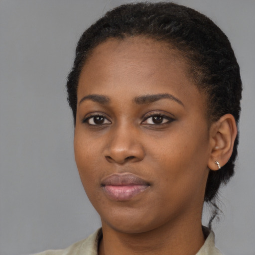 Joyful black young-adult female with medium  black hair and brown eyes