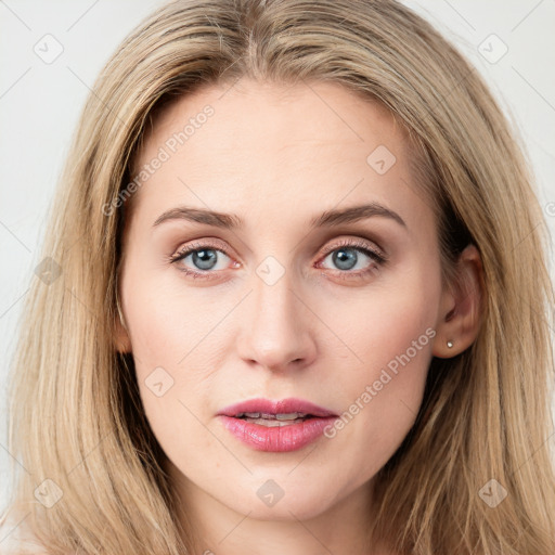 Joyful white young-adult female with long  brown hair and blue eyes