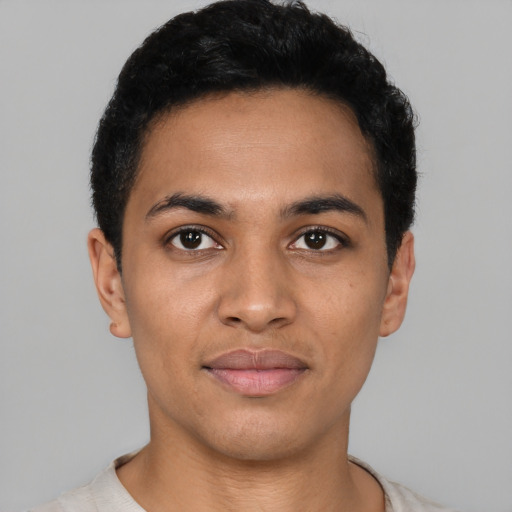 Joyful latino young-adult male with short  black hair and brown eyes