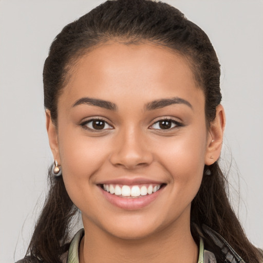 Joyful white young-adult female with long  brown hair and brown eyes